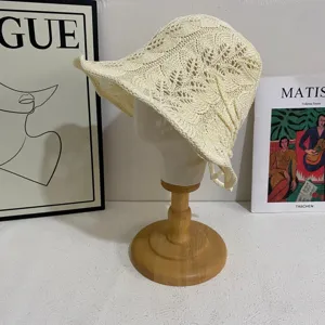 Detail view of Korean style hollow knit bucket hat, breathable cream crochet sun hat close up