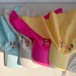 Detailed view of colorful baseball caps with flower embroidery and headscarf design.