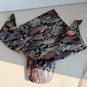 Detailed close-up view of trendy snake print bandana baseball cap, stylish street wear hat.