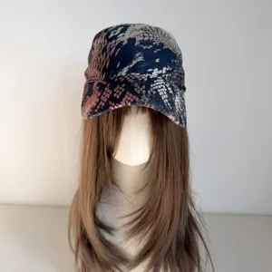 Detail view of the wild snake print pattern on the trendy unisex hip hop bandana cap close up.