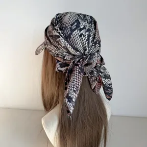 Detailed close-up view showing the trendy snake print headscarf cap and back tie straps.