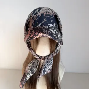Snake print headscarf cap detail, stylish tied design, unique wild fashion accessory.