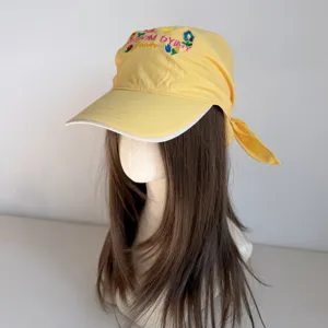 Yellow floral embroidered headscarf baseball cap detail, wide brim sun hat with ribbon tie.
