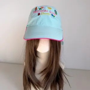 Detailed view of the light blue baseball cap featuring colorful floral embroidery and brim.