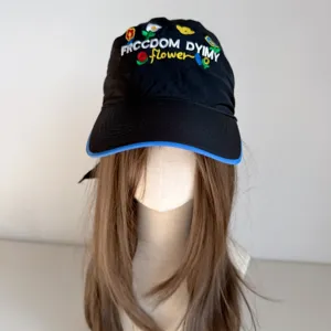 Black embroidered baseball hat with colorful floral design and curved brim detailed view.