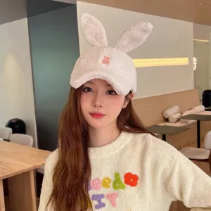 Cute plush rabbit ear baseball cap detail showing soft lamb fleece texture and sweet design.