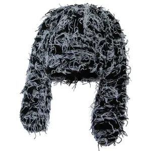 Detailed view of black and white shaggy knit ushanka hat with long ear flaps streetwear style.
