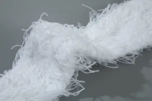 Detailed close-up view of the soft white fluffy plush fabric material, cozy texture.