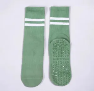 Green non-slip yoga socks for women, mid-tube pilates sports socks with grip dots and stripes.