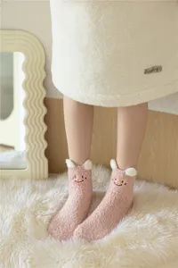 Cozy pink fuzzy plush socks for women, thick warm winter floor socks with cute cartoon embroidery.