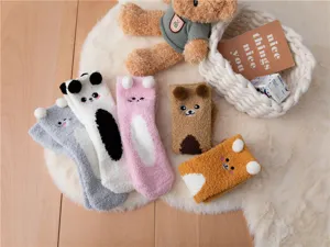 Cozy coral fleece fuzzy sleep socks with cute animal ears and embroidery details in cozy scene.
