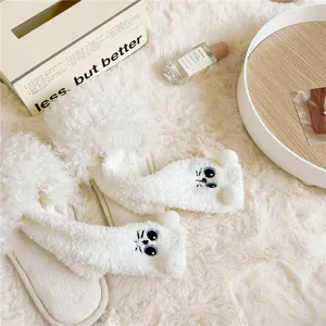 Flauschige Damen Korallenfleece Wintersocken mit süßer Katzenstickerei und flauschigen Pompons.