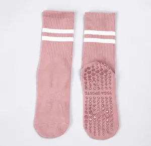 Pink non-slip yoga socks for women, mid-calf pilates and fitness socks with silicone grip.