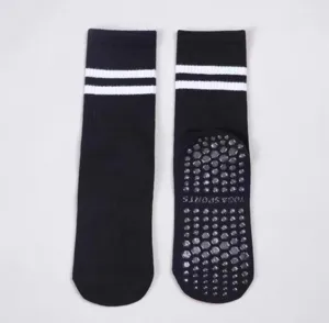 Black non-slip yoga socks with white stripes and silicone grip dots for fitness pilates.