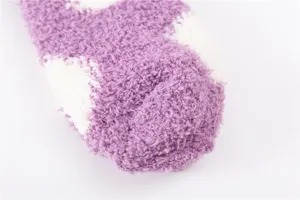 Cozy coral fleece women sleep socks detail view, soft purple and white polka dot design.