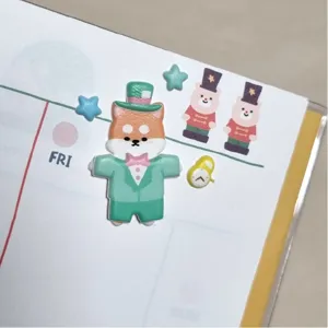 Cute puffy sticker detail showing a dog in green suit with stars and bear design for journaling.