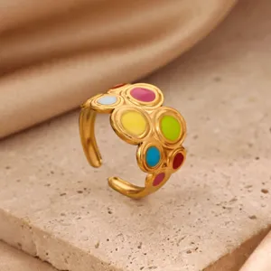 Detailed view of a gold-plated stainless steel open ring featuring vibrant multi-color enamel dots.