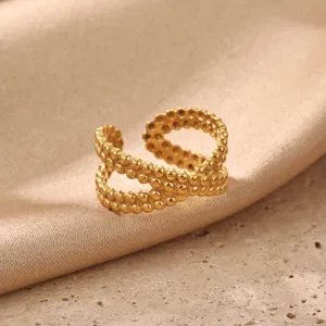 Exquisite gold stainless steel beaded open ring detail, stylish cross design jewelry piece.