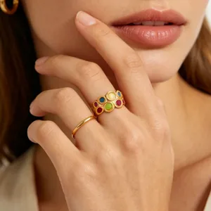 Close-up shot of colorful dopamine enamel gold-plated ring detail, elegant hand model jewelry.