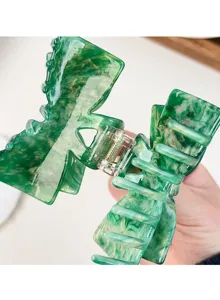 Green acetate bow hair claw clip detail, elegant shark clip for women daily styling.