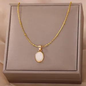 Exquisite detail close-up of the elegant oval white stone pendant necklace on a jewelry box.