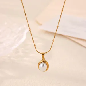 Close-up detail of the elegant gold titanium steel pearl pendant necklace, minimalist style.
