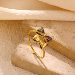 Detail shot of women's stainless steel double bow ring paved with colorful cubic zirconia.