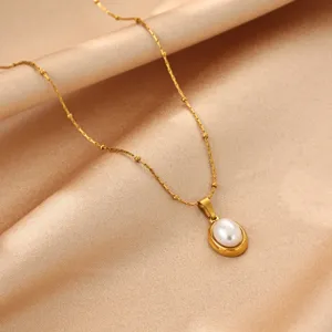 Close-up detail of the elegant oval pearl pendant on a delicate gold titanium steel chain.