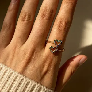Gold-plated stainless steel double heart ring featuring sparkling multicolor cubic zirconia stones.