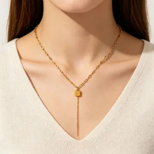 Gold Y necklace with square star pendant, delicate detail shot of elegant sweater chain.