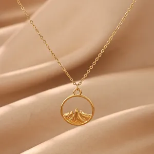 Close-up view of the elegant gold mountain pendant necklace featuring a delicate chain detail.