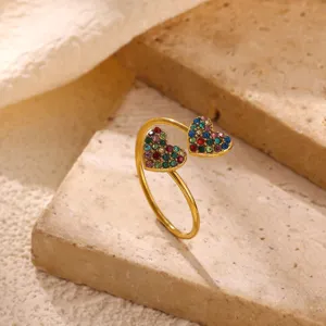 Close-up detail of a stylish double heart open ring, sparkling colorful rhinestones set.