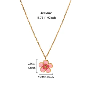 Detail view of the pink enamel flower pendant necklace with gold plated stainless steel chain.