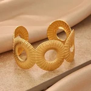 Close-up detail of the textured metal geometric cuff bracelet showcasing its unique radial design.