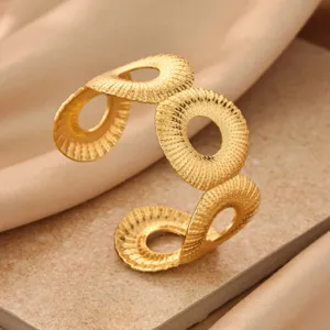 Minimalist gold geometric cuff bracelet with pleated texture, chic open adjustable design for women.