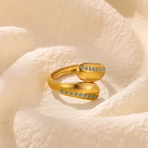 Detail view of the open geometric ring in gold tone with blue enamel dots, crafted for women.