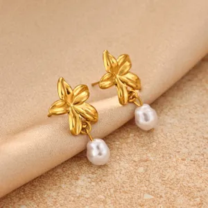 Close-up detail of 18k gold plated stainless steel sunflower earrings with pearls.