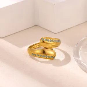 Detailed view of the trendy 18k gold plated stainless steel open ring with blue oil drops.