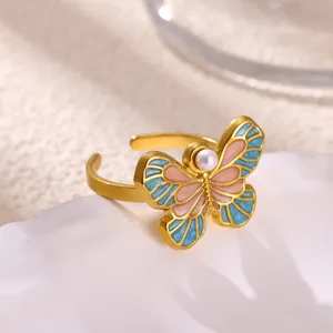 Exquisite 18K gold-plated butterfly open ring with blue pink enamel and pearl detail close-up.