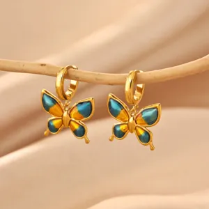 Gold stainless steel butterfly drop earrings with blue yellow enamel gradient design.