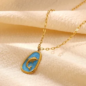 Close-up detail of the gold-plated dolphin pendant necklace with blue enamel finish.