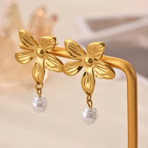Gold sunflower flower earrings with hanging pearl details, elegant stainless steel jewelry for women.