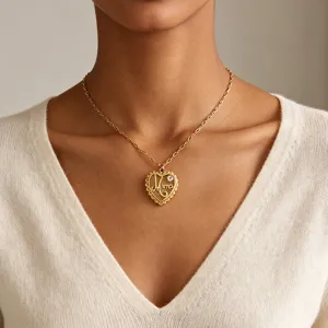 Close-up detail of gold stainless steel heart pendant necklace with Mama engraving and sparkling zircon.