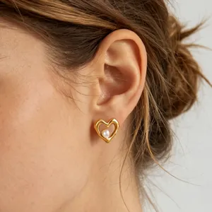 Gold plated heart pearl stud earrings, elegant and luxurious detail jewelry design.