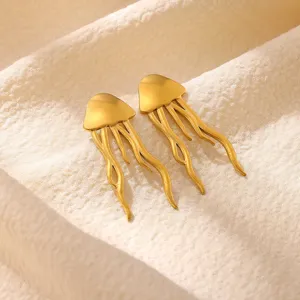 Close-up view of elegant gold jellyfish earrings showcasing exquisite metallic texture details.