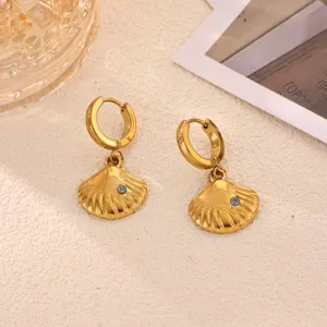 Detailed view of trendy gold stainless steel seashell hoop earrings with blue zircon stone.
