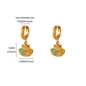 Gold stainless steel shell drop earrings with blue crystal, elegant jewelry detail display.