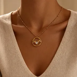 Gold plated stainless steel heart MOM zircon pendant necklace detail close-up view.