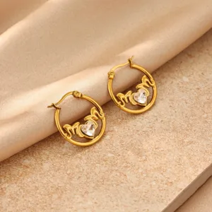 Detail shot of gold-plated stainless steel MOM hoop earrings featuring sparkling heart zircon stone.