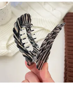 Black and white patterned hair claw clip, flat shell design for elegant buns and daily styling.